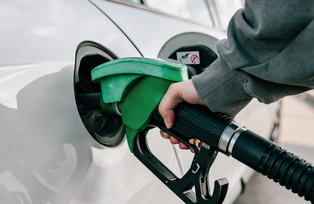 Hand Refilling Car With Fuel At Gas Station